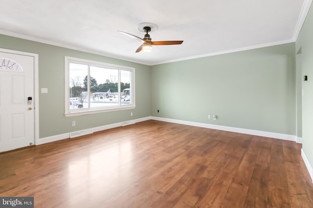 entryway featuring ceiling fan, wood-type flooring, and ornamental molding