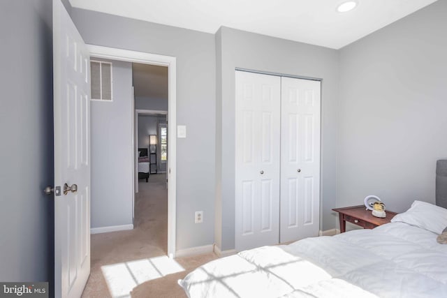 bedroom with light colored carpet and a closet