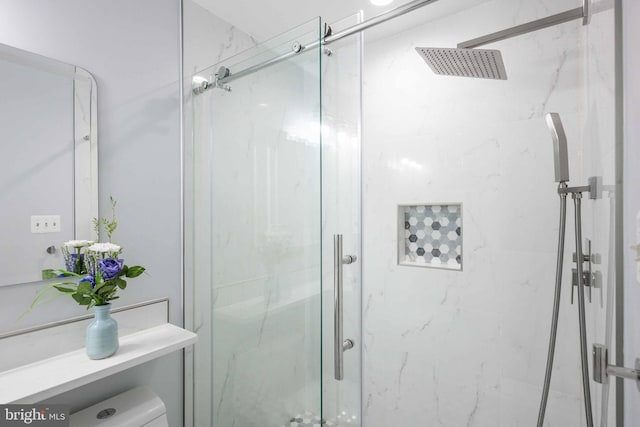 bathroom with toilet and an enclosed shower