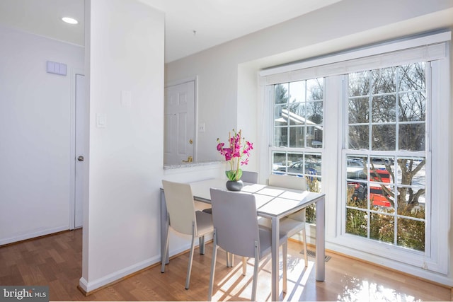 dining area with hardwood / wood-style flooring and plenty of natural light