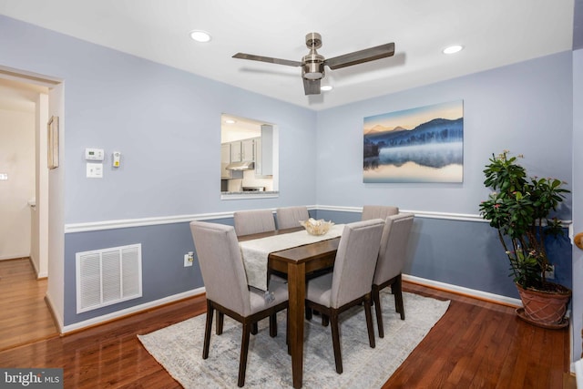 dining space with ceiling fan and dark hardwood / wood-style flooring