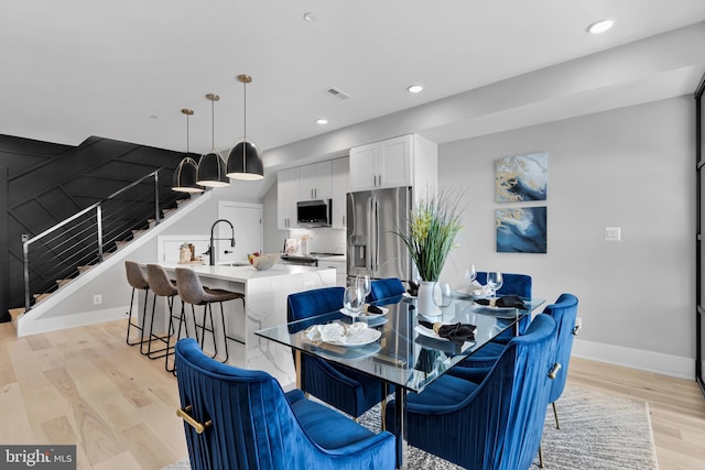 dining room featuring light hardwood / wood-style floors and sink