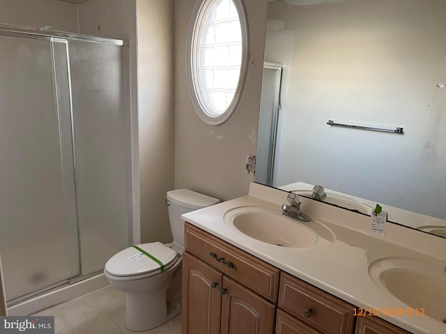 bathroom with vanity, toilet, and an enclosed shower