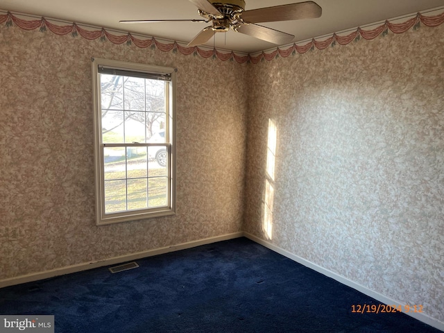 empty room with carpet flooring and ceiling fan