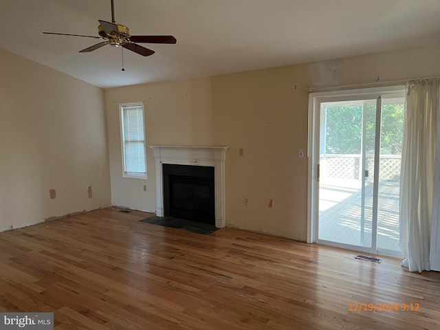 unfurnished living room featuring light wood-type flooring and ceiling fan