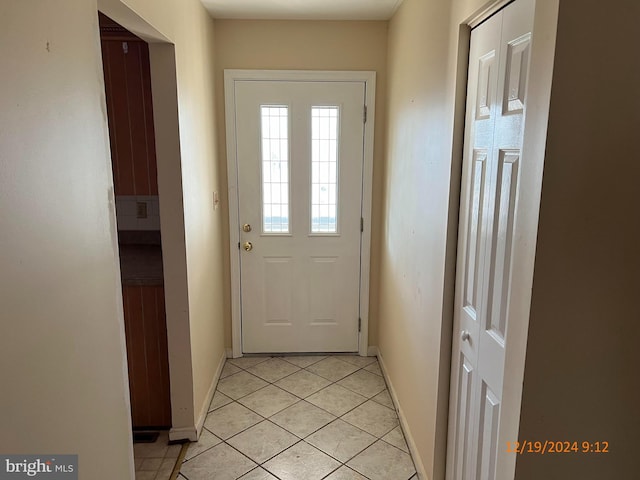 doorway with light tile patterned floors