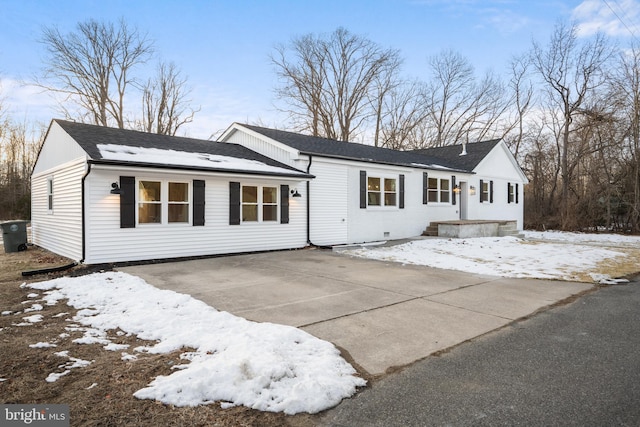 single story home featuring driveway and roof with shingles