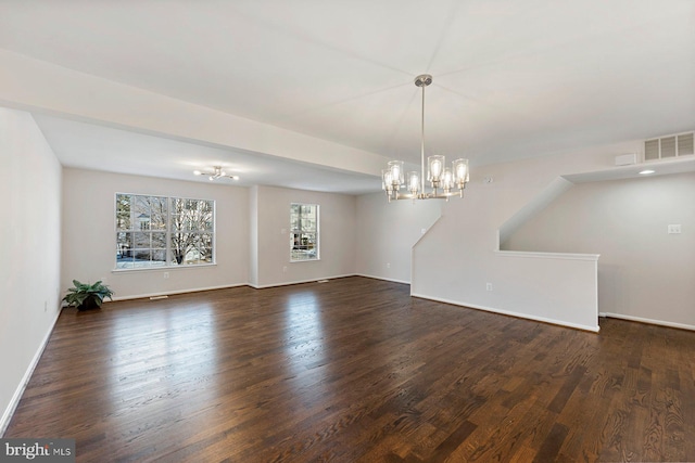 unfurnished room featuring dark wood-type flooring and a chandelier