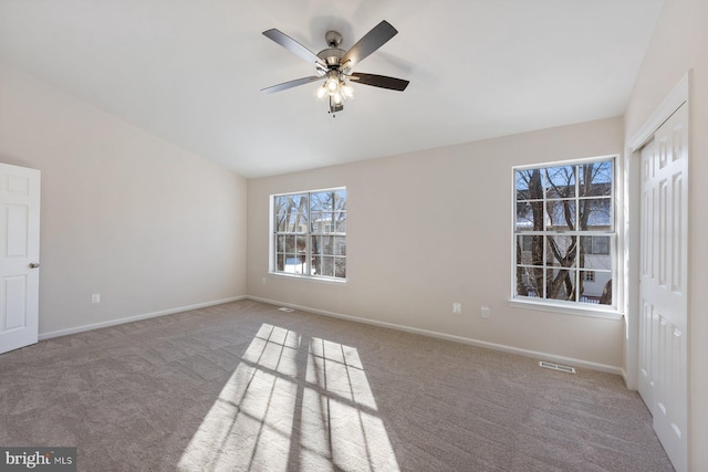 spare room featuring ceiling fan and carpet flooring