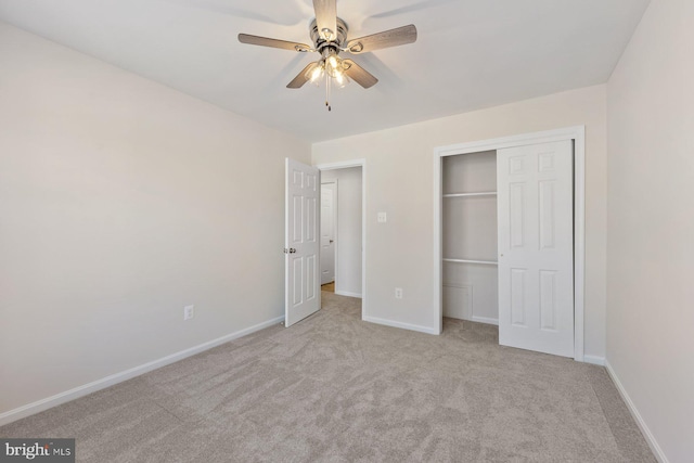 unfurnished bedroom featuring ceiling fan, light colored carpet, and a closet