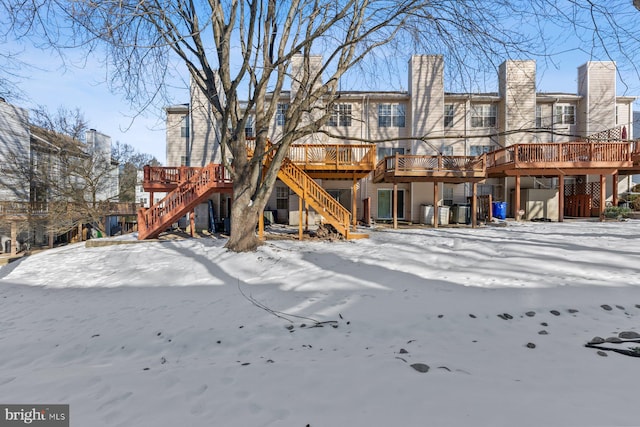 snow covered house with a deck