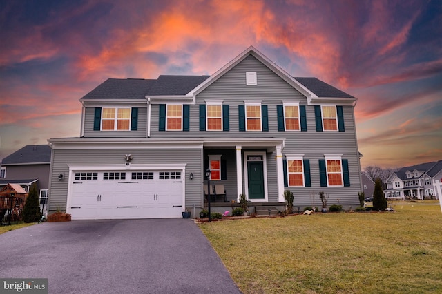 view of front facade featuring a garage and a yard