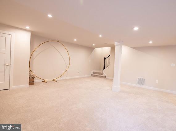 basement featuring light colored carpet