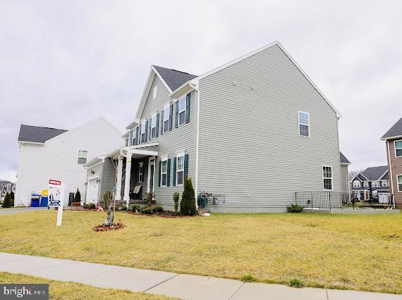 view of property exterior featuring a lawn