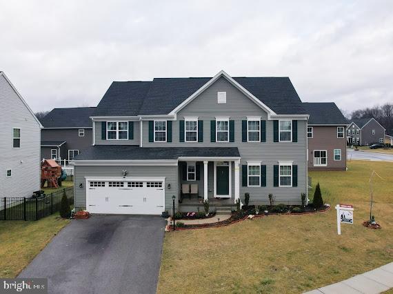 view of front of property with a garage and a front yard