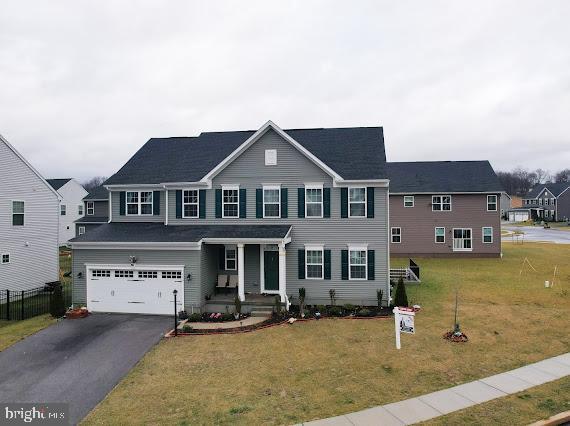 view of front of home with a garage and a front lawn