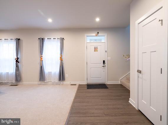 entryway with dark wood-type flooring and a wealth of natural light