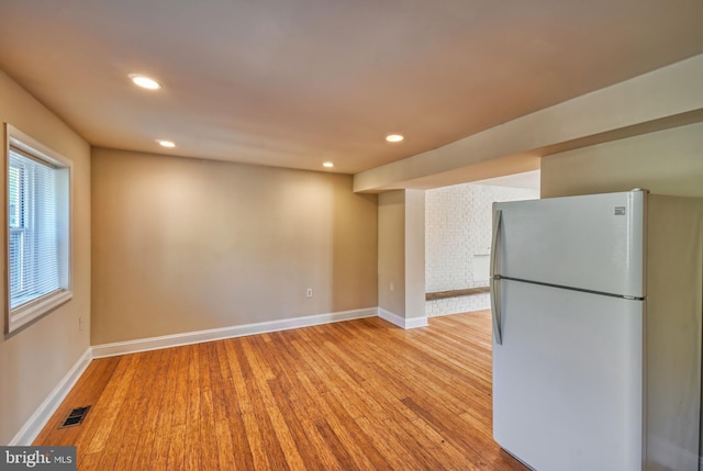 kitchen with white fridge and light hardwood / wood-style flooring