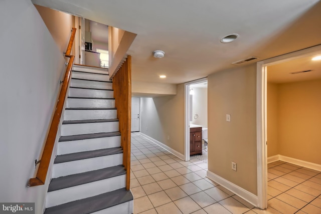 stairs featuring tile patterned floors