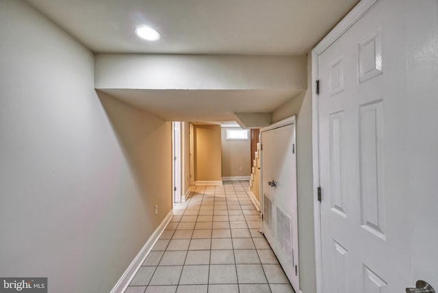 hall featuring light tile patterned flooring