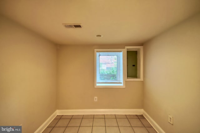 tiled empty room featuring electric panel