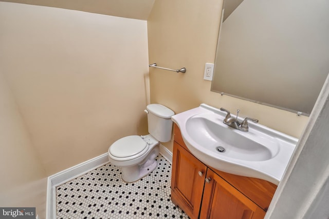 bathroom with tile patterned flooring, vanity, and toilet