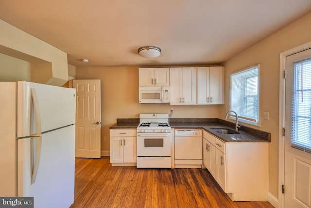 kitchen with white cabinetry, sink, dark hardwood / wood-style floors, and white appliances