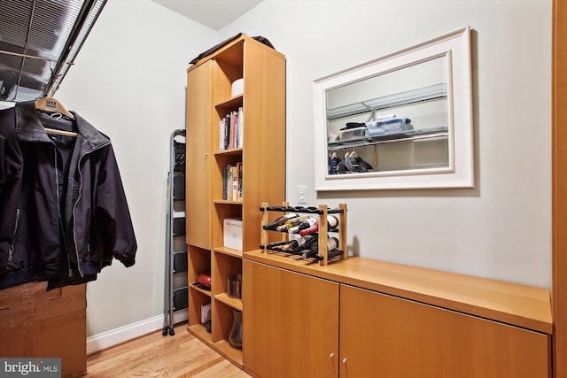 walk in closet with light wood-type flooring