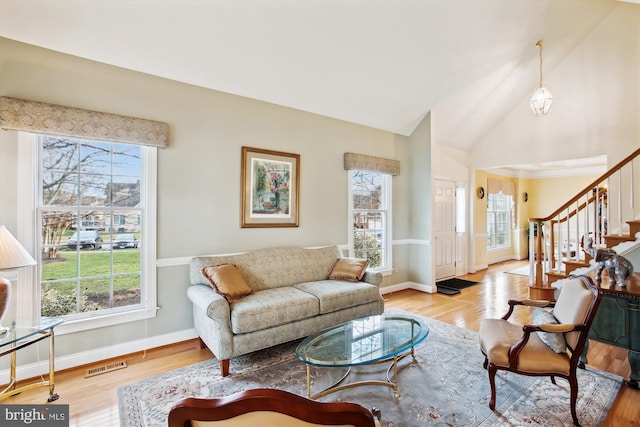 living room featuring light hardwood / wood-style floors and lofted ceiling