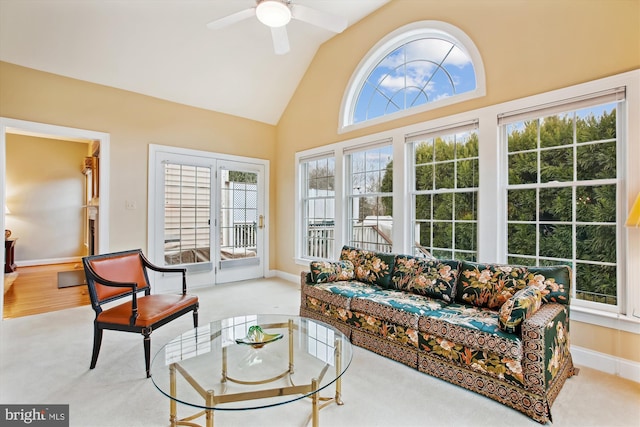 sunroom / solarium with ceiling fan and lofted ceiling