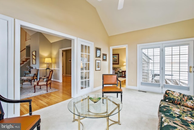 interior space featuring light carpet, french doors, and lofted ceiling