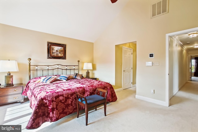 carpeted bedroom with crown molding and high vaulted ceiling