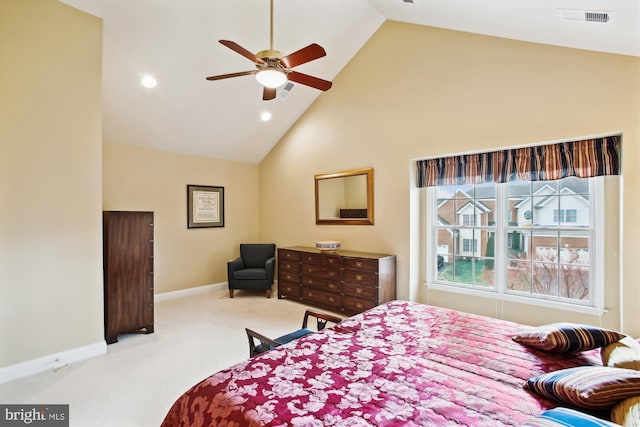 carpeted bedroom with ceiling fan and high vaulted ceiling