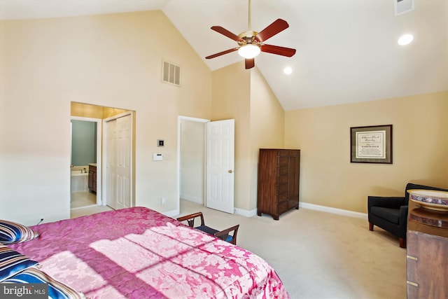 carpeted bedroom featuring a closet, high vaulted ceiling, ensuite bath, and ceiling fan