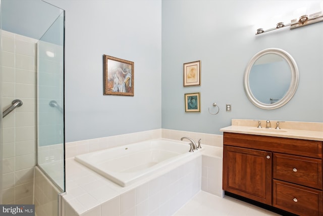 bathroom with tile patterned floors, vanity, and independent shower and bath