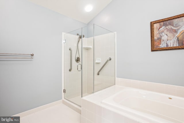 bathroom featuring tile patterned floors, independent shower and bath, and vaulted ceiling