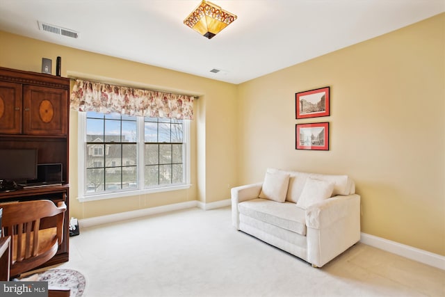 sitting room featuring light carpet