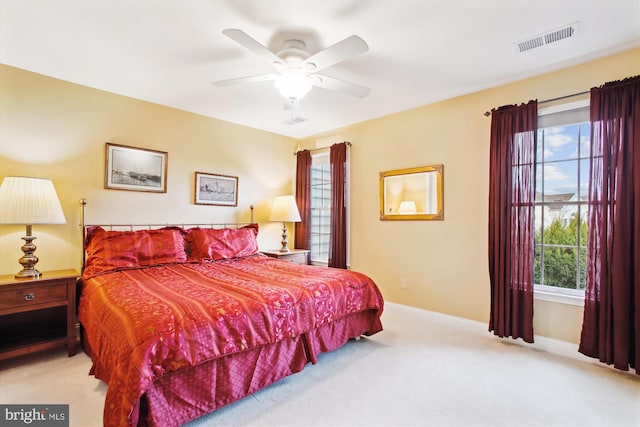 bedroom featuring light carpet and ceiling fan