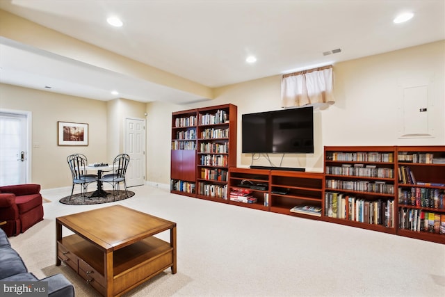 carpeted living room featuring electric panel