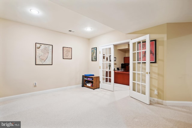 interior space with carpet flooring and french doors