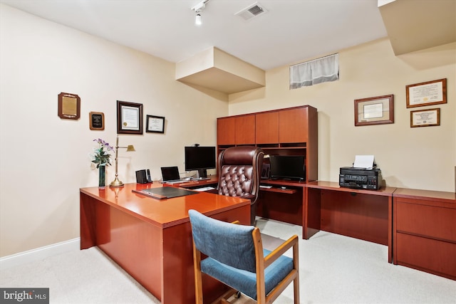 home office featuring rail lighting and light colored carpet