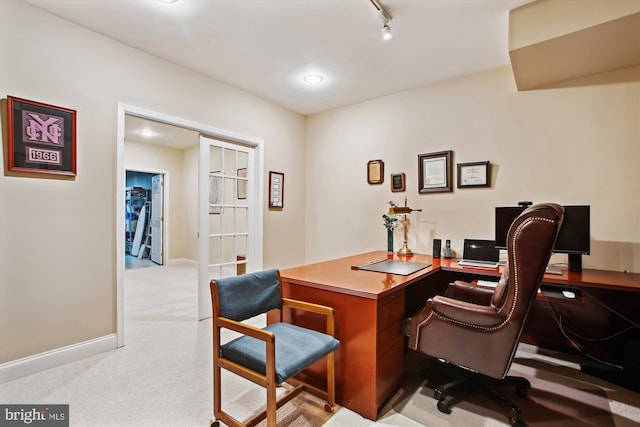 carpeted home office with track lighting