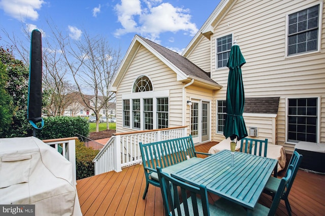 wooden terrace featuring a grill