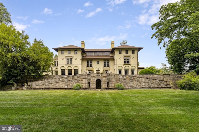 back of house with a lawn