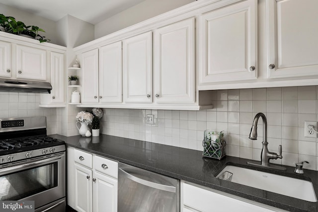 kitchen featuring backsplash, sink, stainless steel appliances, and white cabinetry