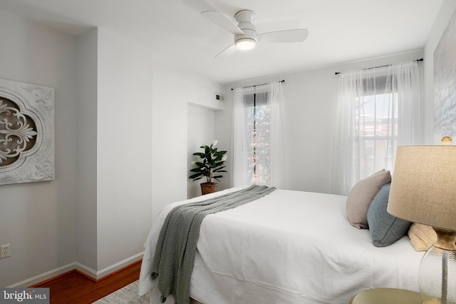 bedroom with ceiling fan and wood-type flooring