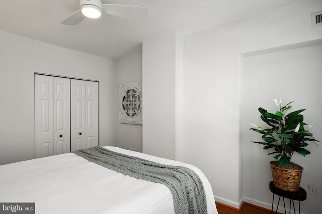 bedroom with ceiling fan and a closet