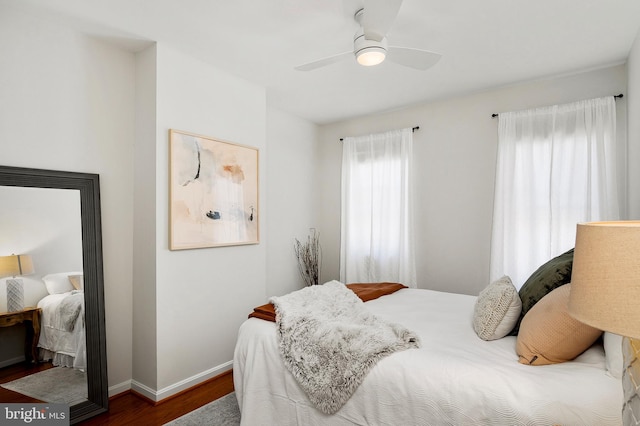 bedroom with ceiling fan and dark wood-type flooring