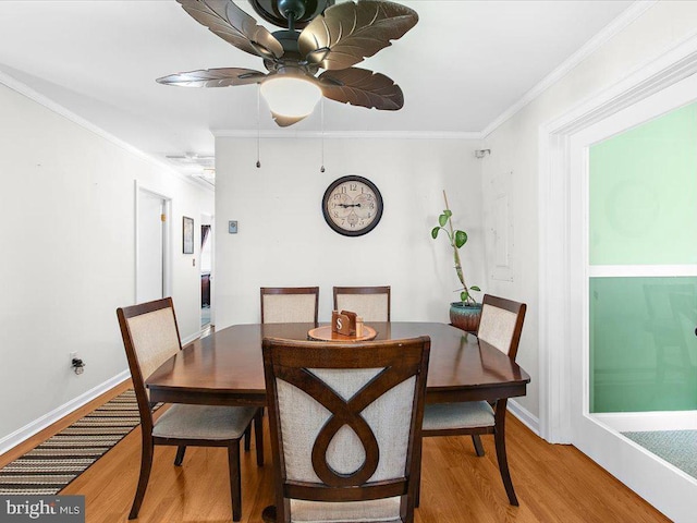 dining room featuring hardwood / wood-style floors, ceiling fan, and crown molding