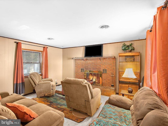 living room featuring wood walls, ornamental molding, and a brick fireplace